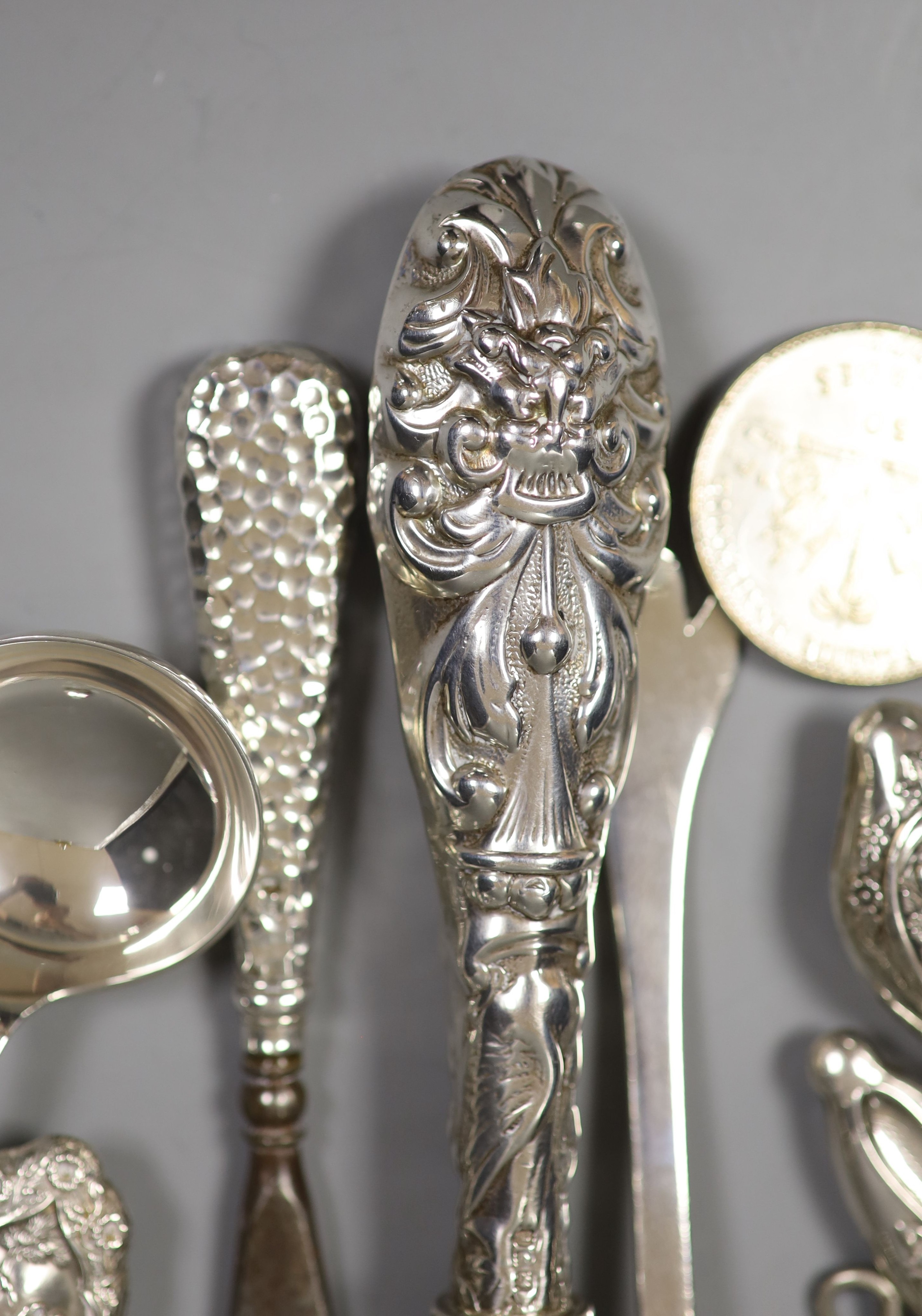 Assorted button hooks and other small silver including spoons, magnifying glass, glove stretchers, shooting related medallion and enamelled stamp case, etc.